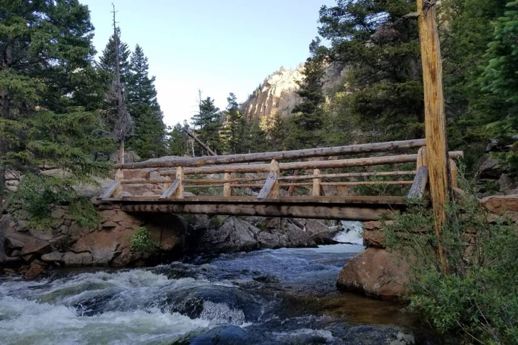 a photo of a bridge and stream at Rocky Mountain National Park. A great day trip excursion